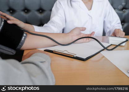 Doctor checking patient arterial blood pressure. Health care.