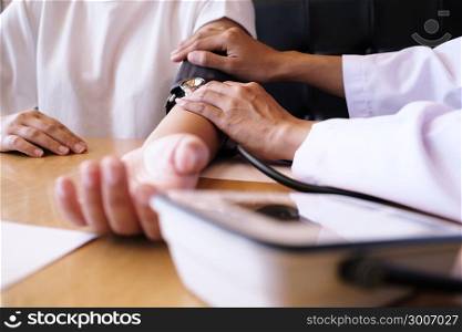 Doctor checking patient arterial blood pressure. Health care.