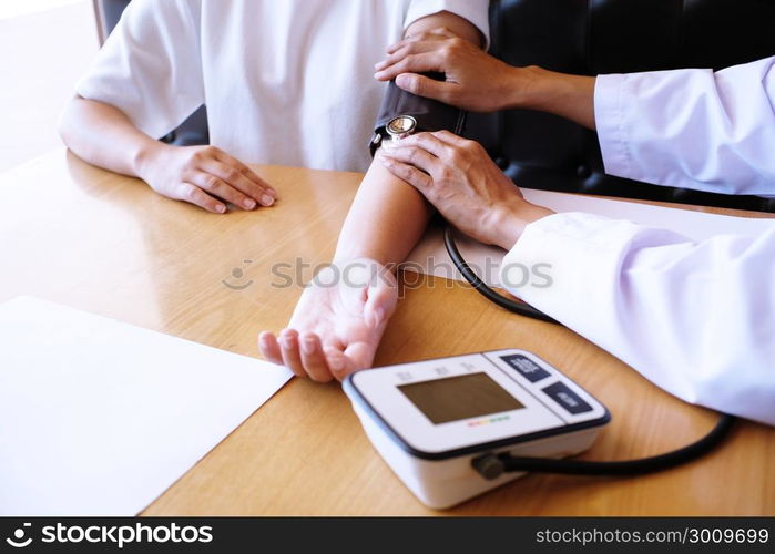 Doctor checking patient arterial blood pressure. Health care.