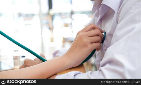 Doctor checking patient. Doctor examines a patient with a stethoscope. Health, Hospital and Medical concept.