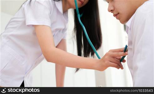 Doctor checking patient. Doctor examines a patient with a stethoscope. Health, Hospital and Medical concept.