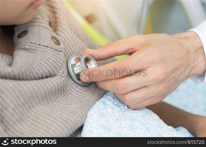 Doctor checking patient heart beat with stethoscope. Physical examination check in the hospital, Medical and healthcare concept
