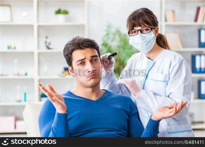 Doctor checking patients ear during medical examination