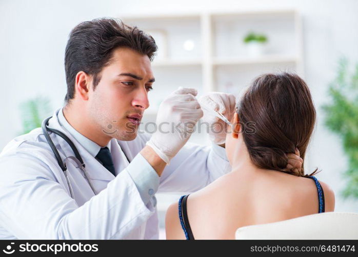 Doctor checking patients ear during medical examination