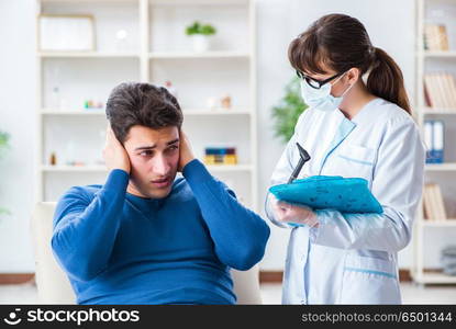 Doctor checking patients ear during medical examination