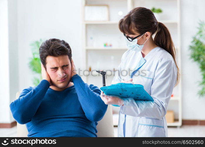 Doctor checking patients ear during medical examination