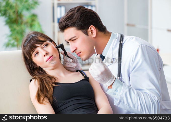 Doctor checking patients ear during medical examination