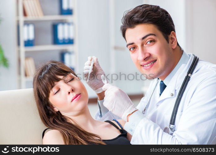 Doctor checking patients ear during medical examination