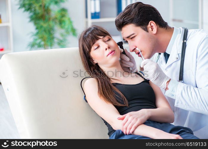 Doctor checking patients ear during medical examination