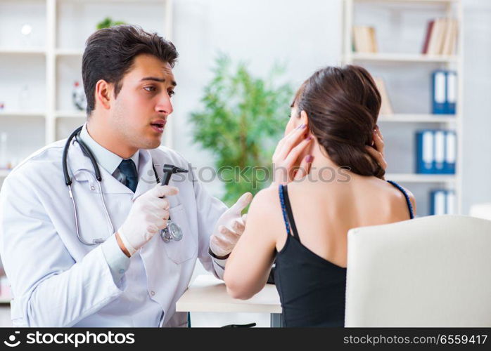 Doctor checking patients ear during medical examination