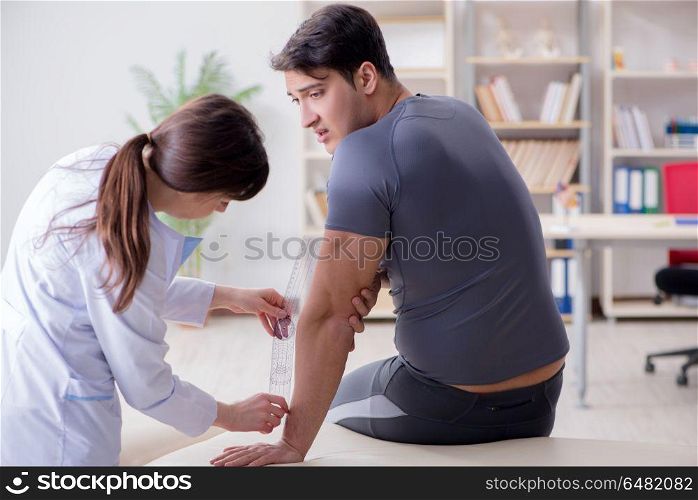 Doctor checking patients joint flexibility with gonimeter