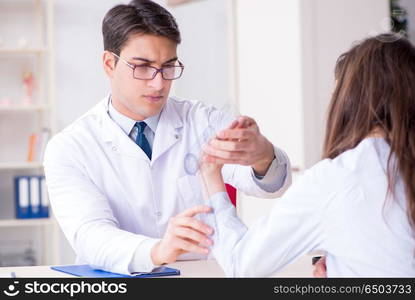 Doctor checking patients joint flexibility with gonimeter