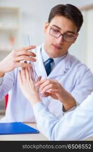 Doctor checking patients joint flexibility with gonimeter