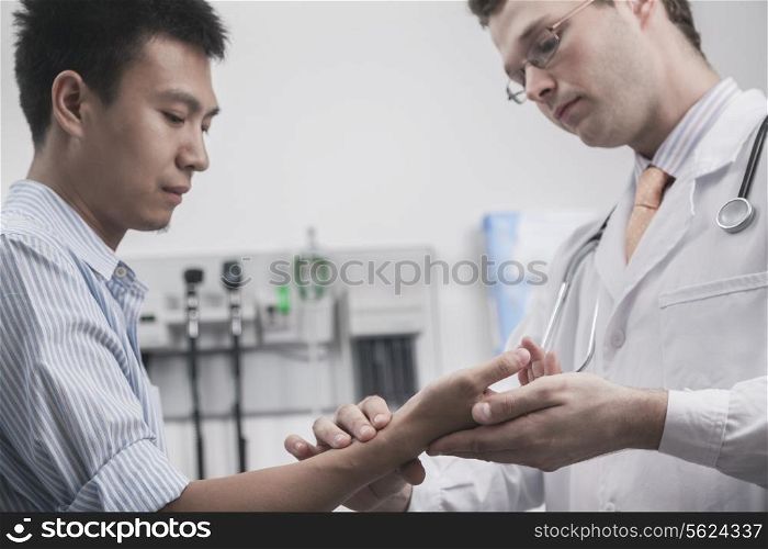 Doctor checking patients pulse on the wrist