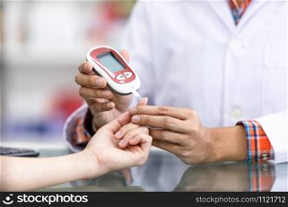 doctor checking sugar in blood patients in the hospital Thailand