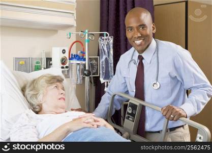 Doctor Checking Up On Patient Lying In Hospital Bed