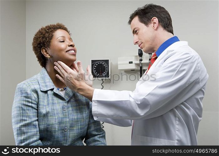Doctor checking womans throat