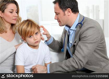 Doctor cheking little boy&acute;s ear infection