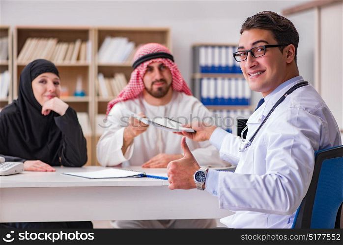 Doctor consulting arab family at hospital