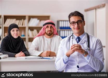 Doctor consulting arab family at hospital