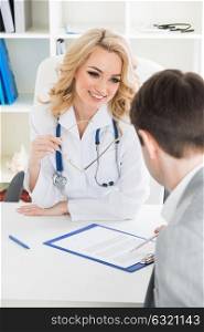 Doctor consulting patient. Doctor consulting patient in a clinical office