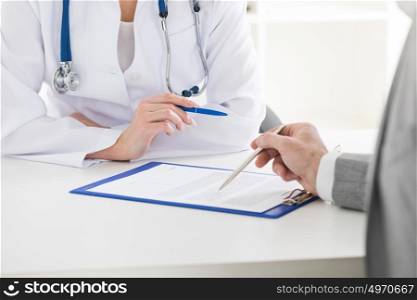 Doctor consulting patient. Female doctor holding consulting patient showing documents