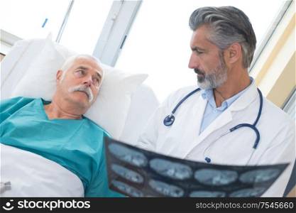 doctor consulting senior patient about his xrays
