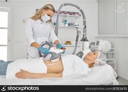 Doctor cosmetologist doing vacuum massage on woman belly. Abdomen spa sculpting procedure. Doctor cosmetologist doing vacuum massage procedure on woman belly