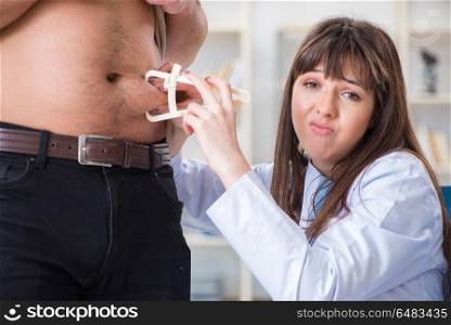 Doctor dietician giving advices to fat overweight patient