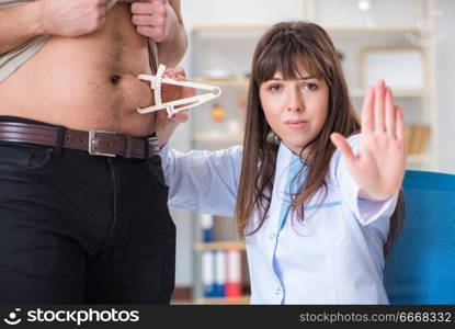 Doctor dietician giving advices to fat overweight patient