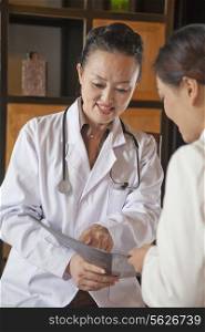 Doctor Discussing Medical Chart with Nurse