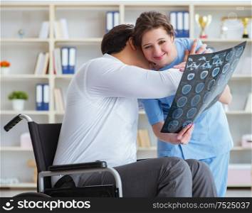 Doctor discussing x-ray image with patient. The doctor discussing x-ray image with patient