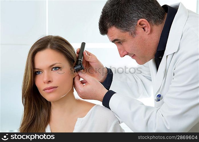 Doctor ENT checking ear with otoscope to woman patient at hospital