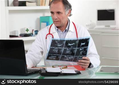 Doctor entering x-ray results into his database