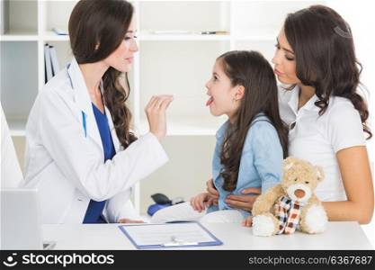 Doctor examine child&rsquo;s throat. Little girl and her mother at pediatrician office. Doctor examine child&rsquo;s throat