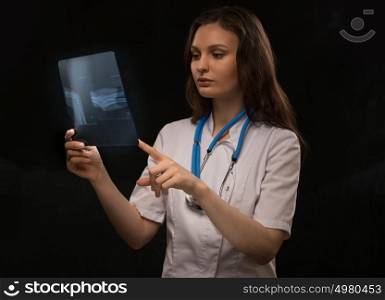 Doctor examining an arm bones radiography