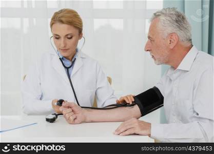 doctor examining blood pressure