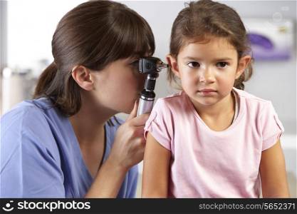 Doctor Examining Child&#39;s Ears In Doctor&#39;s Office