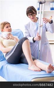 Doctor examining injured woman in hospital