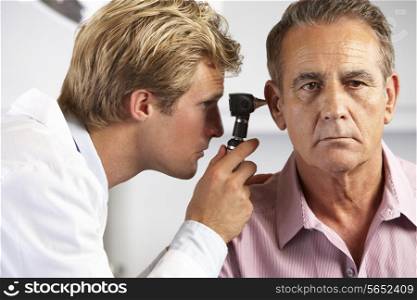 Doctor Examining Male Patient&#39;s Ears