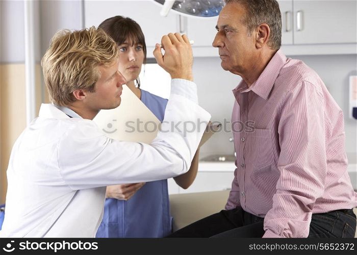 Doctor Examining Male Patient&#39;s Eyes