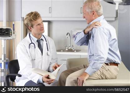 Doctor Examining Male Patient With Shoulder Pain