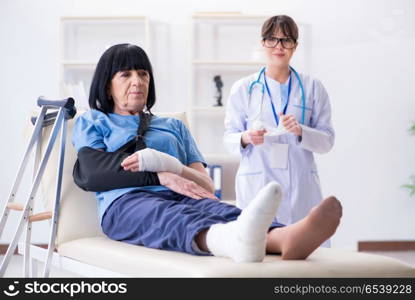 Doctor examining old mature woman after incident