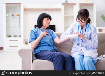 Doctor examining old mature woman after incident