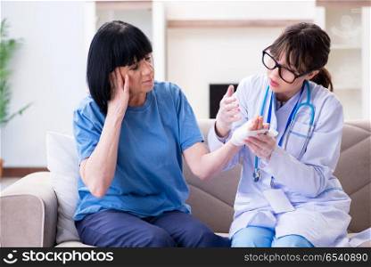 Doctor examining old mature woman after incident