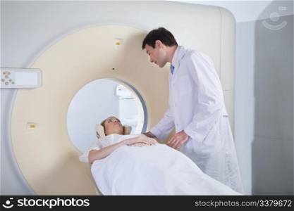 Doctor examining patient before CT scan