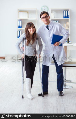 Doctor examining patient with broken leg