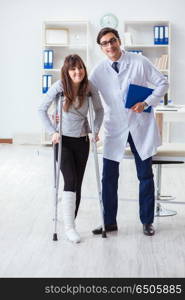 Doctor examining patient with broken leg