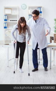 Doctor examining patient with broken leg