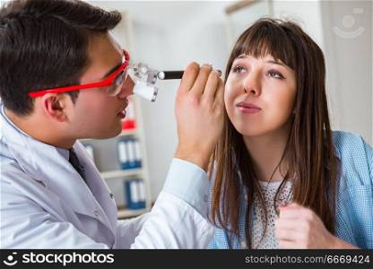 Doctor examining patients eye in hospital